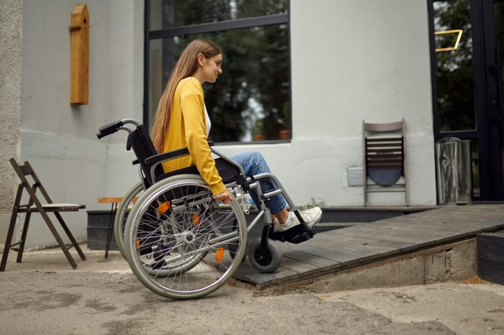 Disabled student in wheelchair at the ramp in cafe